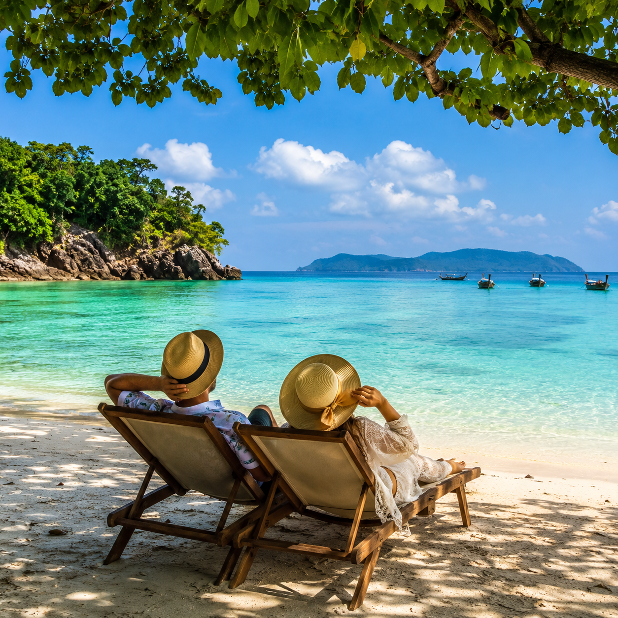 Couple relaxing on an Andaman beach on their honeymoon